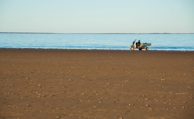 The wide sandy beach of lake and a flat horizon