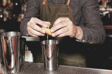 Bartender is adding egg white to shaker, making flip cocktail