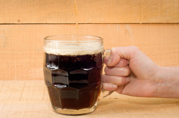 mug flow beer hand wooden background