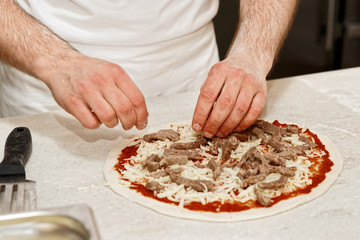 Making of a meat pizza