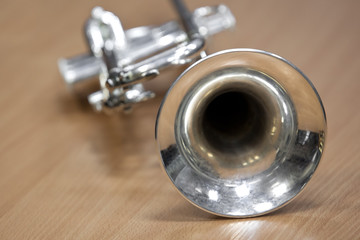  Fragment of trumpet lying on the table closeup