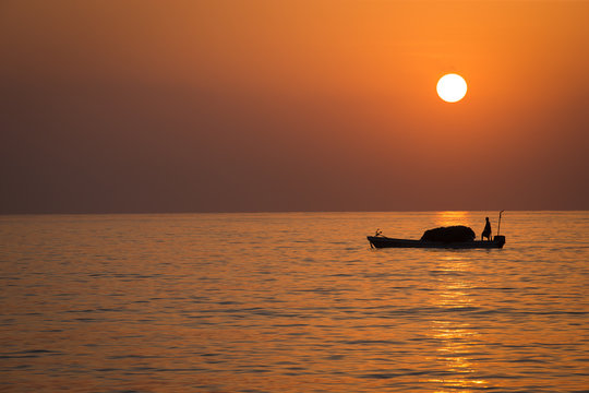 Sunrise over the indian ocean with fishing boats