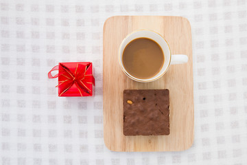 A cup of coffee with brownie cake