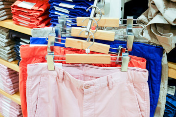 Colorful trousers on rack