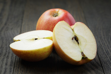 ripe apples sliced on wood table