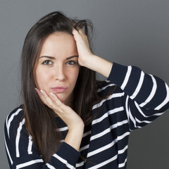 doubt and reflection concept - confused 20s cute brunette seeking for ideas or solutions in messing...