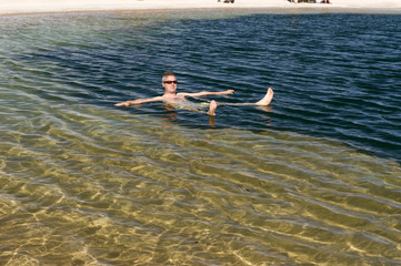 Floating in a salty Cejas lagoon, Atacama desert, Chile