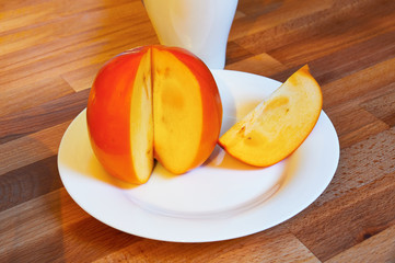 Asian juicy orange persimmon closeup