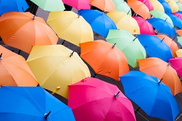 Many colorful umbrellas in city settings. Kosice, Slovakia. Top view. Color background