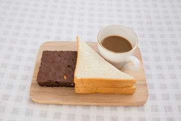 A cup of coffee with brownie cake and sandwich