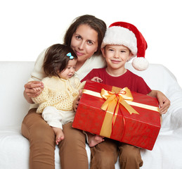 Fototapeta na wymiar happy family with box gift, woman with child in santa helper hat - christmas holiday concept