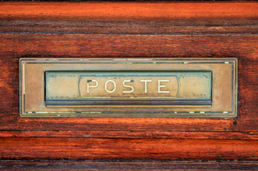 Close-up details of an aged post sign on a door.  