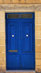 Details of a blue front door in Malta.