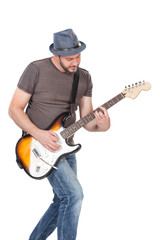 man with hat and beard play on electric guitar with enthusiasm. Isolated on white