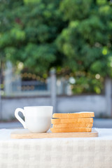 A cup of coffee with sandwich