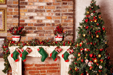 Fototapeta na wymiar Christmas stockings on a fireplace. Christmas interior design 