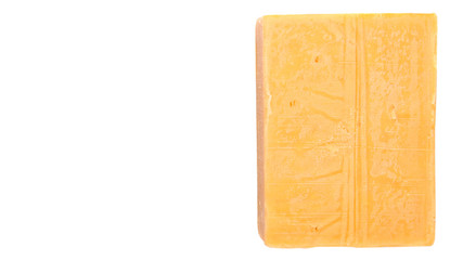A block of cheddar cheese over white background
