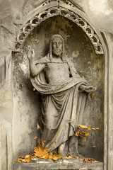 Historic Jesus on the autumn mystery old Prague Cemetery, Czech Republic