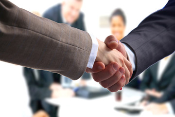 Business handshake. Two businessman shaking hands with each other in the office