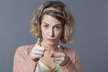 doubt and worry concept - upset 20s woman with blond curly hair looking concerned recognizing or...