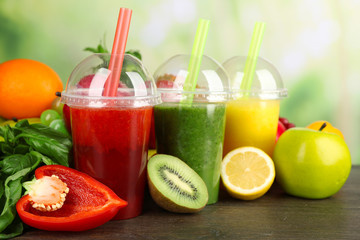 Fresh juice mix fruit, healthy drinks on wooden table, on bright background