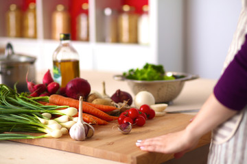 Young Woman Cooking in the kitchen. Healthy Food