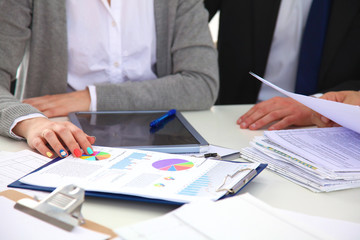 Image of business partners discussing documents and ideas at meeting