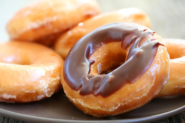Chocolate glazed donuts background image. Macro with shallow dof.