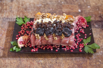 raw pork with prune nuts and pomegranate