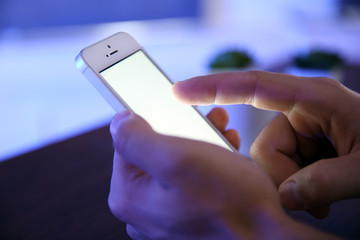 Young man using his smart phone, close up