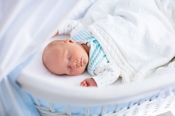 Cute newborn baby in white bed