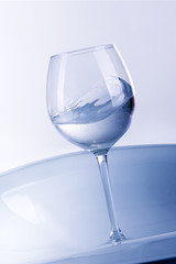 Water splashing from glass isolated on white background