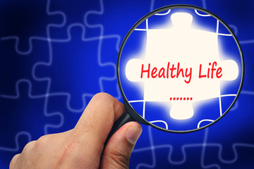 Healthy life word. Magnifier and puzzles.