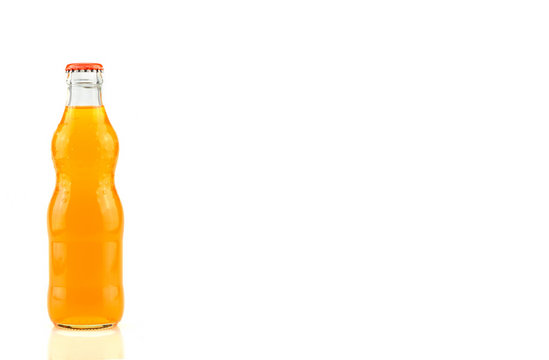 Glass bottle of orange soda isolated on white background