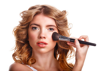 Obraz premium Girl with curly hair straightens makeup brush.