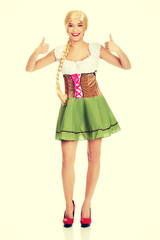 Woman in Bavarian dress with thumbs up.