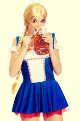 Beautiful bavarian woman drinking beer.