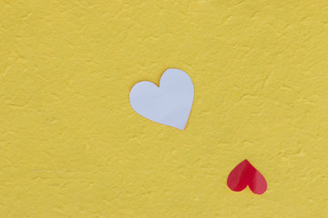 Red heart on yellow paper background, love concept