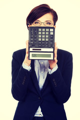 Businesswoman with SOS writing on calculator.