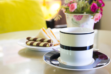 Coffee cup in coffee shop with snack.