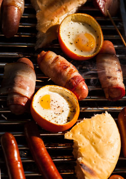  sausages, eggs, bread, pita bread, mushrooms on the grill