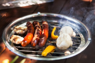 sausages and mushrooms on the grill 