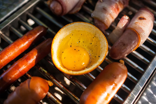 sausages, eggs, bread, pita bread, mushrooms on the grill