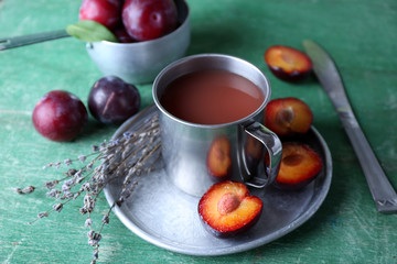 Delicious plum juice with fruits on wooden table close up