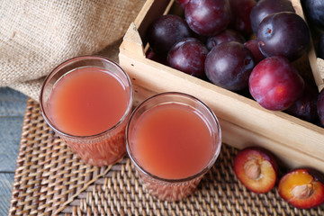 Delicious plum juice with fruits on table close up © Africa Studio