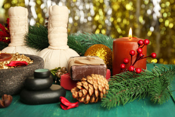 Beautiful Christmas presents composition on green wooden table against sparkle background, close up