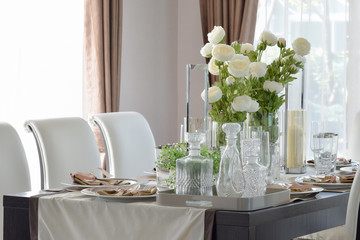 dining wooden table and comfortable chairs in modern home with e