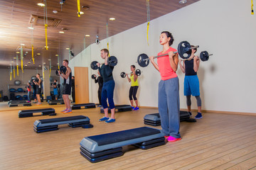 Obraz premium Sport, fitness, lifestyle and people concept - group flexing muscles with barbells in gym
