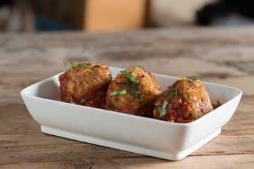 Meatball with tomato sauce in white plate. Selective focus.