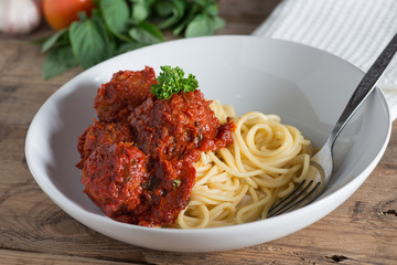 Spaghetti and Meatballs in white plate.